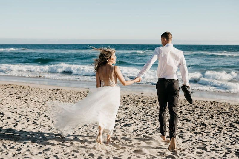 Glückliches Brautpaar Barfuß am Strand