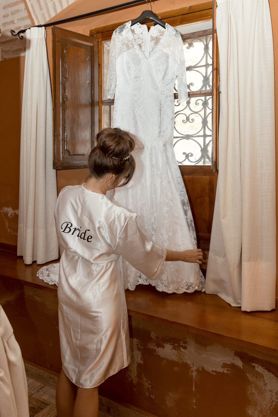 Die Braut guckt sich ihr Hochzeitskleid an.